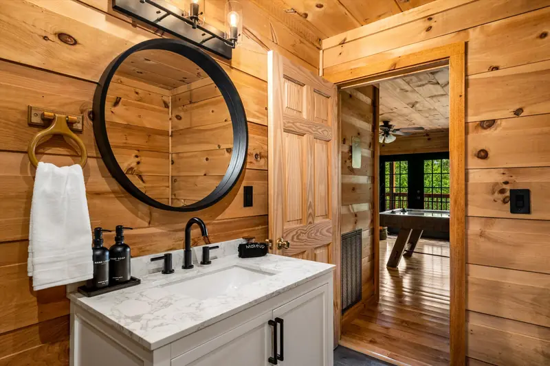 Bathroom vanity with a second door open through to the game room