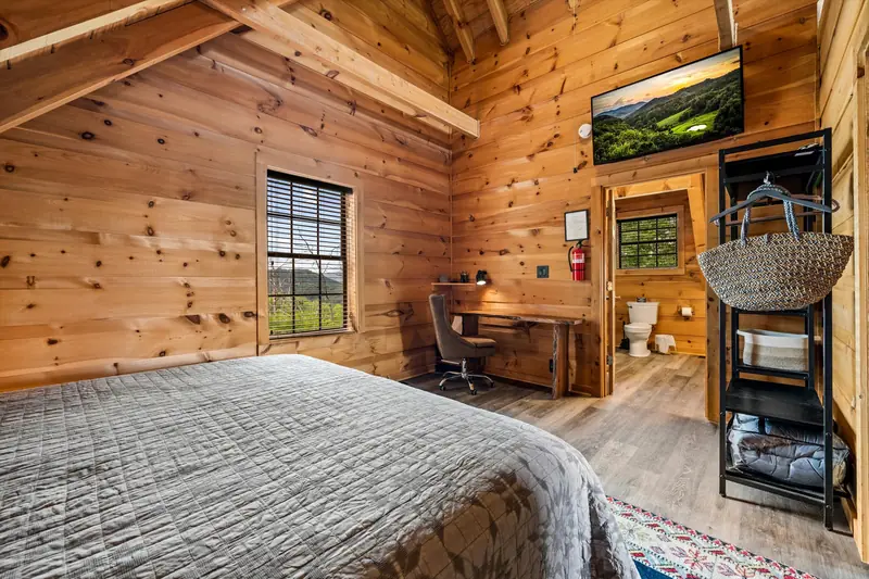 A bedroom with a desk and window at Acorn Ridge